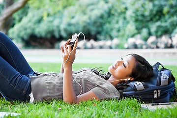 Image showing Asian college student listening to music