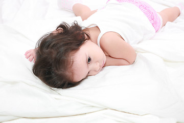 Image showing adorable toddler girl on the bed at home