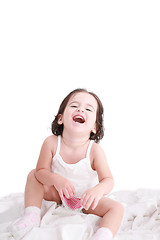 Image showing laughing little girl on her bed