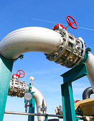 Image showing Industrial zone, Steel pipelines and valves against blue sky