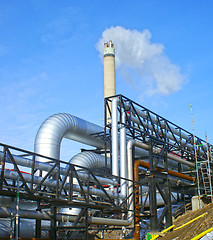 Image showing Industrial zone, Steel pipelines and valves against blue sky