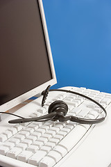 Image showing headset on the computer keyboard (blue)