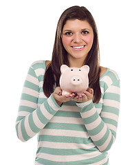 Image showing Ethnic Female Holding Piggy Bank on White