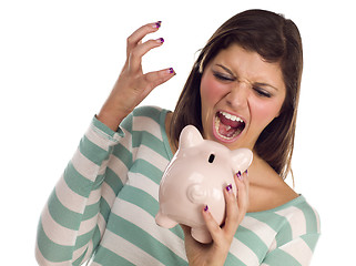 Image showing Ethnic Female Yelling At Piggy Bank on White