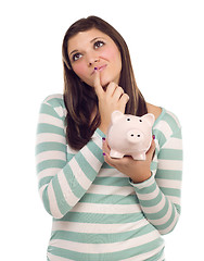 Image showing Ethnic Female Daydreaming and Holding Piggy Bank on White