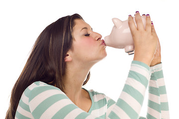 Image showing Ethnic Female Kissing Pink Piggy Bank on White