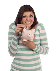 Image showing Ethnic Female Putting Coin Into Piggy Bank on White