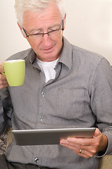 Image showing Senior working on a tablet pc