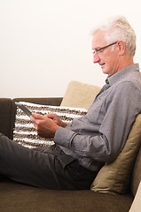 Image showing Senior working on a tablet pc