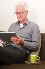 Image showing Senior working on a tablet pc