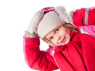 Image showing The laughing girl wearing red overalls and mittens with snow