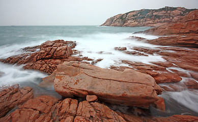 Image showing rocky sea coast and blurred water 