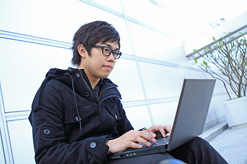 Image showing man using computer outdoor 