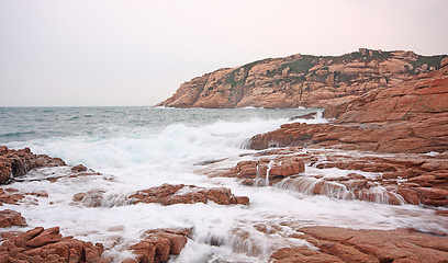 Image showing rocky sea coast and blurred water 