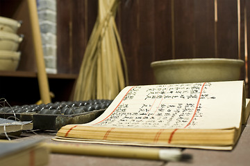 Image showing abacus and book on the table in a chinese old shop 