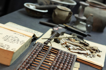 Image showing abacus and book on the table in a chinese old shop