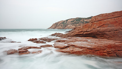 Image showing rocky sea coast and blurred water 