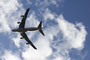 Image showing A large airplane tilting right