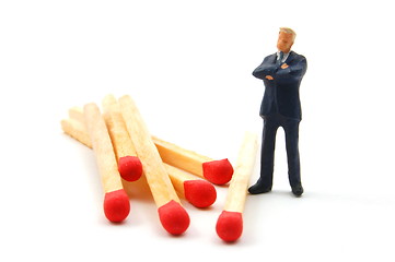 Image showing business man and matches on white