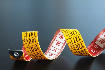 Image showing measuring tape on blue background