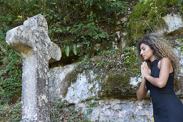 Image showing Woman praying with eyes closed