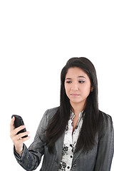 Image showing portrait of angry female looking at cellphone, isolated on white