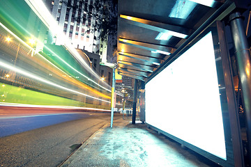 Image showing white display advertising with traffic at night 