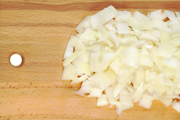 Image showing Chopped onions on a wooden board