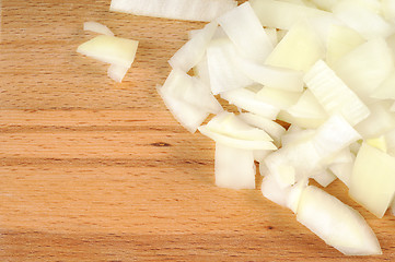 Image showing Chopped onions on a wooden board