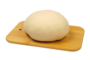 Image showing Flour the dough on a wooden board