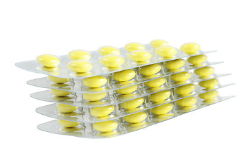 Image showing Several packs of yellow pills