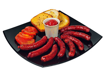 Image showing Plate with grilled sausages and ketchup