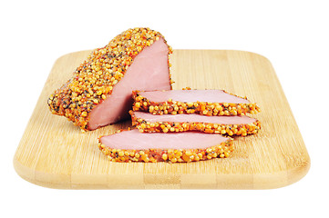 Image showing Piece of a ham with spices on a wooden board