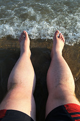 Image showing Symbol vacation at sea. Feet on the beach