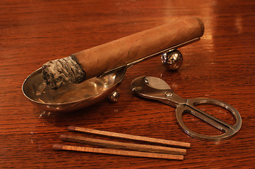 Image showing Cigar on a stand with matches&cutters