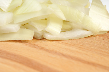 Image showing Chopped onions on a wooden board