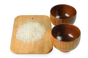 Image showing Wooden bowls for rice. Handful of rice