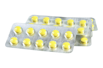 Image showing Several packs of yellow pills