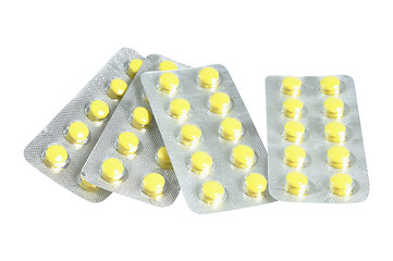 Image showing Several packs of yellow pills