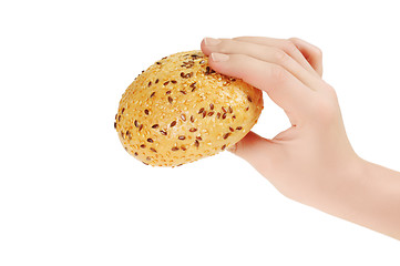 Image showing Bun, topped with sesame seeds in hand