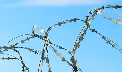 Image showing Barbed wire on blue sky.