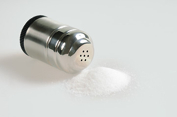 Image showing Salt shaker and spilled salt