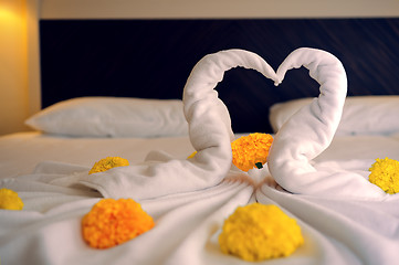 Image showing Bed Suite decorated with flowers and towels.