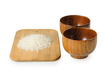 Image showing Wooden bowls for rice. Handful of rice