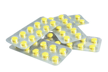 Image showing Several packs of yellow pills