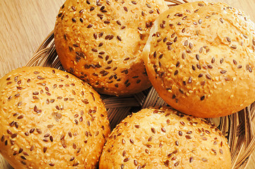 Image showing Bun, topped with sesame seeds in a basket