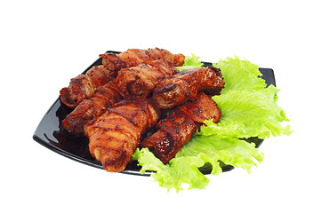 Image showing Roasted meat, wrapped in bacon on the dish