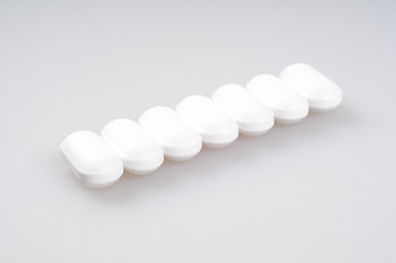 Image showing White pills packed in a row