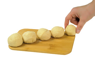 Image showing Flour the dough on a wooden board