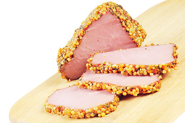 Image showing Piece of a ham with spices on a wooden board